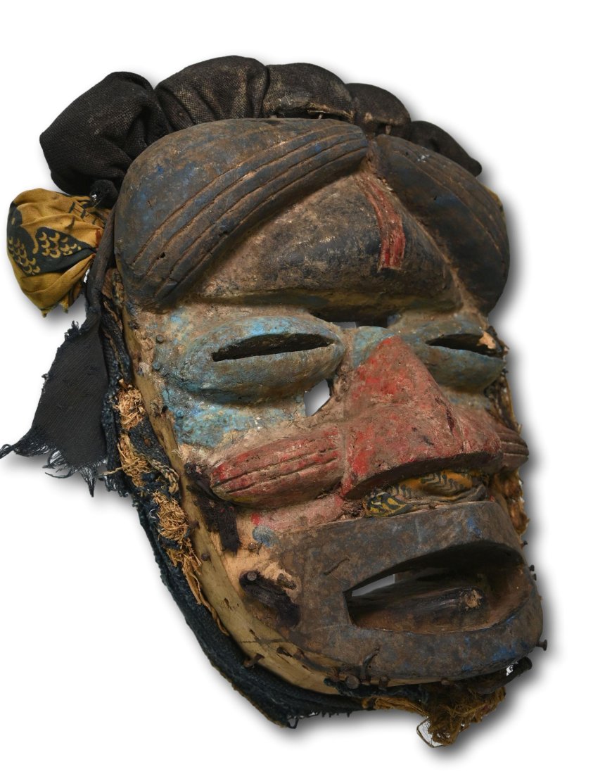 A Guere African Mask: Well weathered and worn, mineral pigments and remains of animal hide, hair, textiles and more suggesting field use and wear as a ceremonial mask. Guere / Wobe peoples, Libera, Africa. The mask measure
