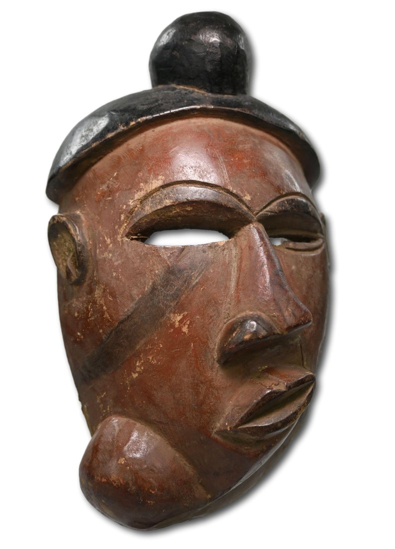 A Vintage Pende Illness Mask: A carved wooden mask with painted surface, and large goiter like form on the neck, suggesting an Illness mask. Pende peoples, DRC/ Congo, Africa. The mask measures 10 x 6 inches.