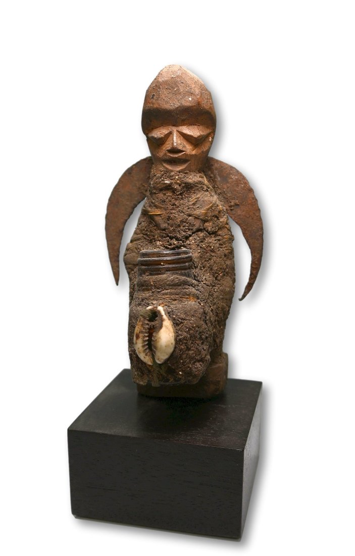 Vodoo Shrine Idol with Bottle: A Carved wooden fetish idol with attached glass bottle, cowrie shell and God of Thunder Iron symbol on its back. Fon peoples, Benin / Togo region, West Africa. The idol measures 6.25 inches tall ( 8.2