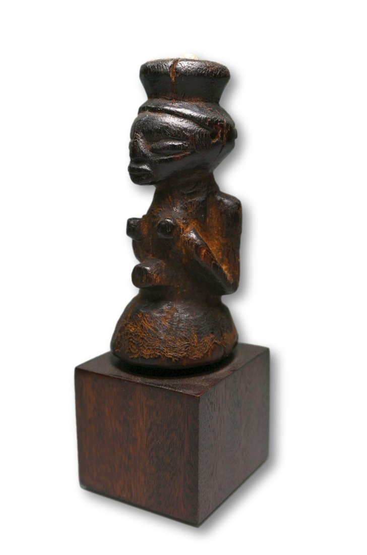 A Kusu Magic Fetish: A Carved wooden diminutive idol with classic features, style and inset silver metal nail. Kusu peoples ,DRC/ Congo, Africa. The idol measures 3.5 inches tall ( 5.25 inches on base) Provenance: Ex Dani