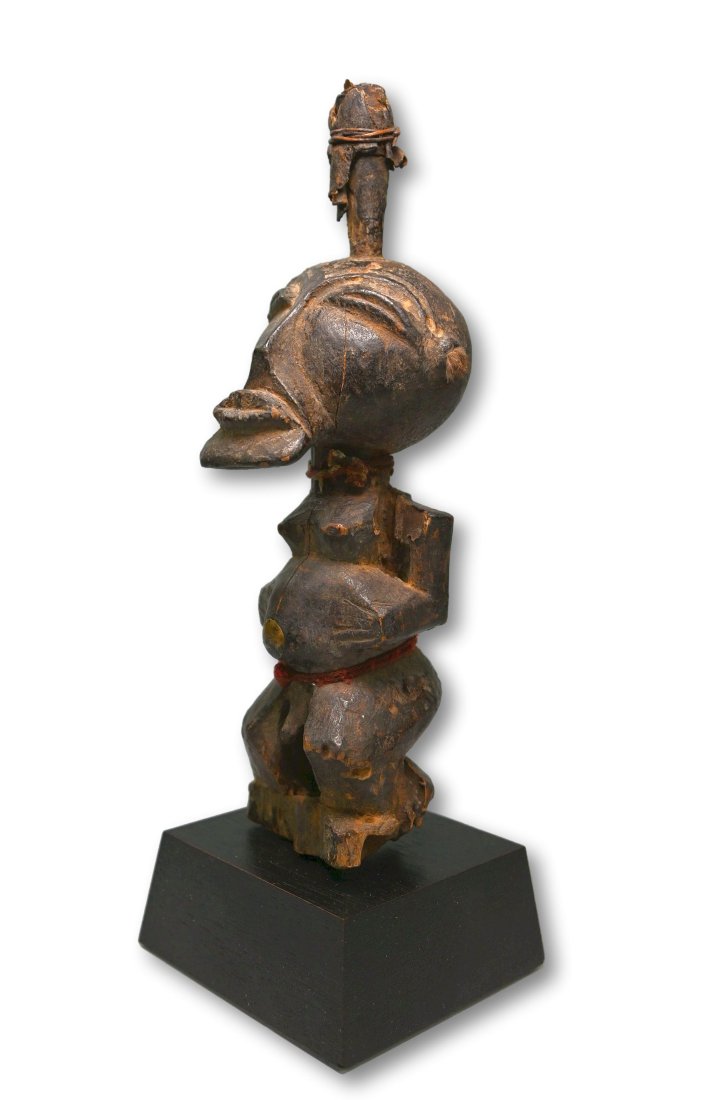 A Songye Shrine Idol: Carved wooden power fetish with exaggerated facial features and weathered surface, inserted animal horn on top. Songye peoples, Congo, Africa. The idol measures 7.25 inches tall ( 8.5 inches on custom