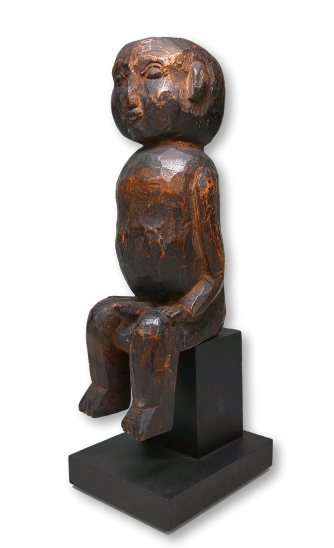 A Balinese Shrine figure: A wonderful folky old carved wooden male effigy, shown seated, possibly for a shrine related to fertility, as the male is shown with erect phallus. Bali, Indonesia. The idol measures 11 inches tall an