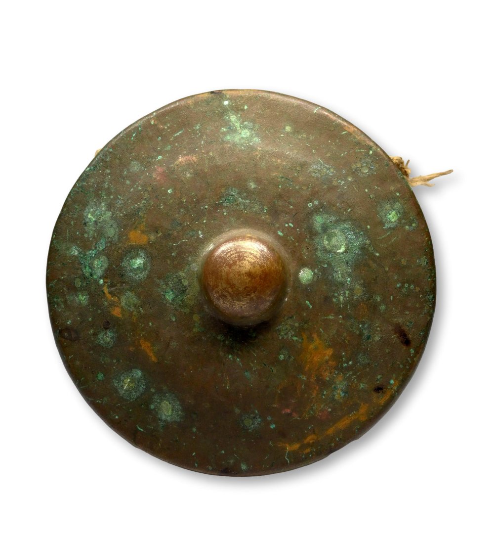 Antique Bronze Gong from Bali: A very old hand late 19th or early 20th century hammered bronze nipple gong with obvious age and field use, likely carried in ceremonial processions. The Gong has a wonderful pure tone when played and