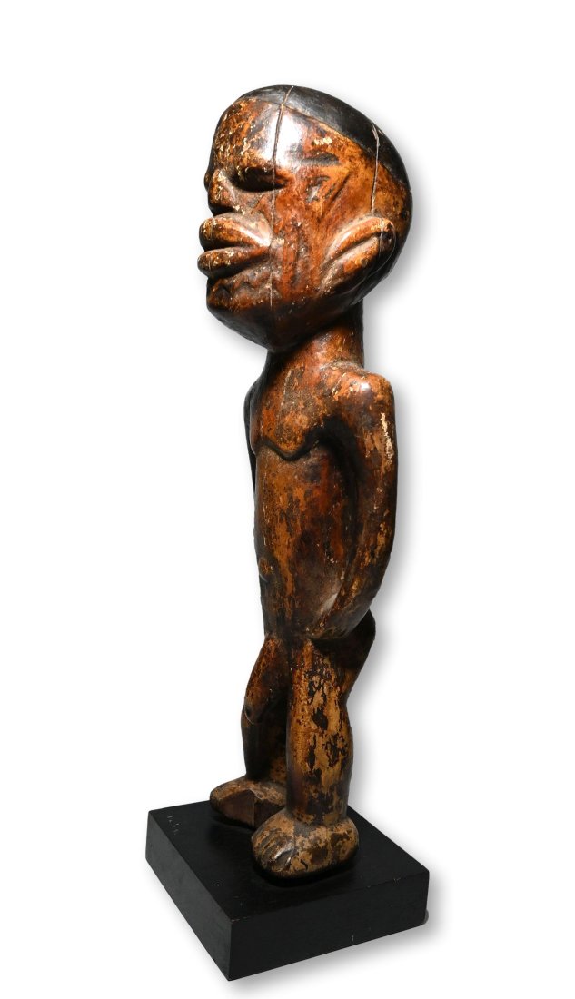 Old Makonde Male Effigy Ex Garcia Collection: A well handled and worn old male effigy with traditional facial scars and a deep well handled surface patina suggesting many years of field use as a ritual object. The figure measures 19.75 inches tal