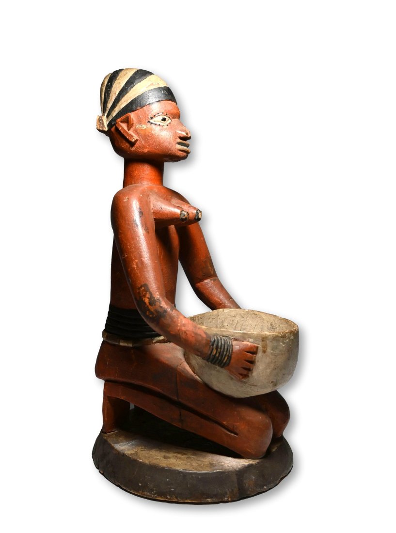Yoruba Kneeling Female Ritual Bowl: Elegant carved wooden female figure shown kneeling with offering bowl, richly decorated with painted designs. Known as a "Olumeye". Yoruba peoples, Nigeria, Africa. The sculpture measures 13 inches ta