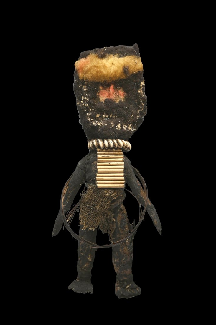 A Rare Mendi Payback Sculpture: A Mendi payback doll. Mendi, Southern Highlands Province, Papua New Guinea.Of typical form, the doll made of mud and clay over a wooden frame, the head with expressive face and human hair attachments 