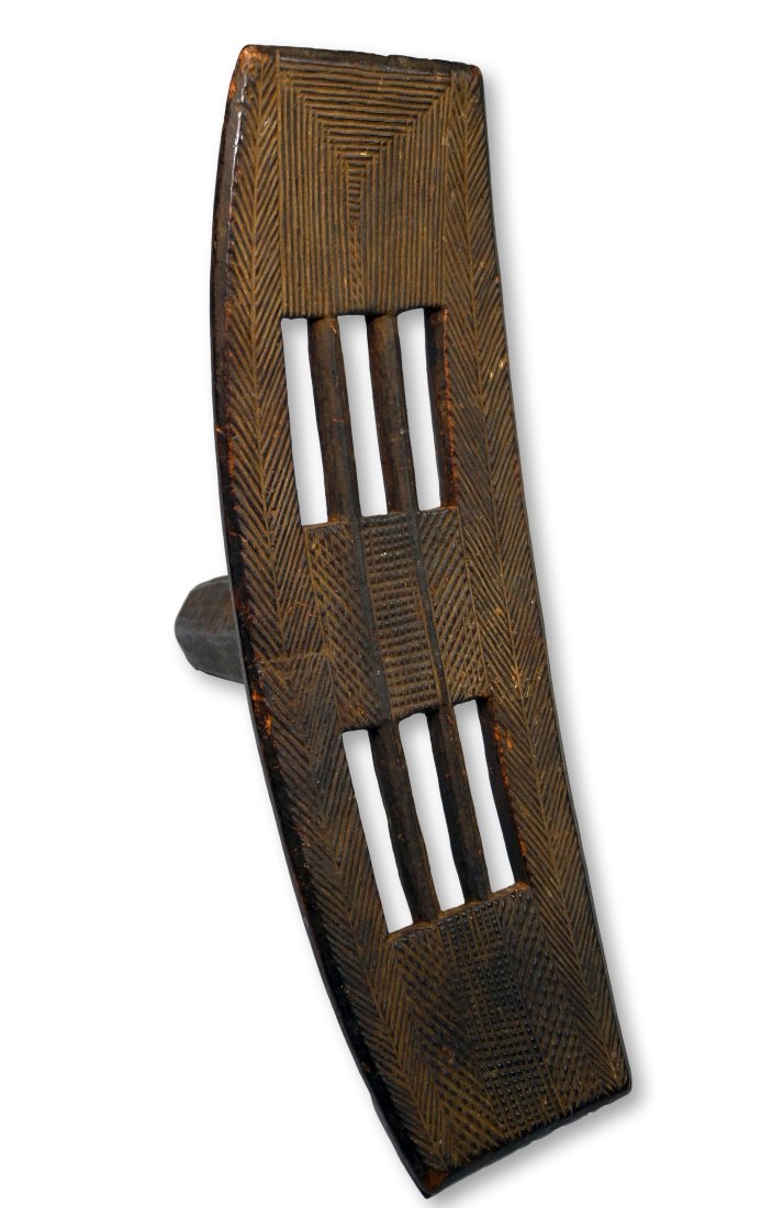 A Very Fine Ngombe Backrest or Stool Ex Gould Collection: A carved wooden backrest or stool with finely incised geometric designs worn smooth from handling. Ngombe peoples, DRC/ Congo, central Africa. The Stool measures 18.25 inches long x 6 inches wide x 7
