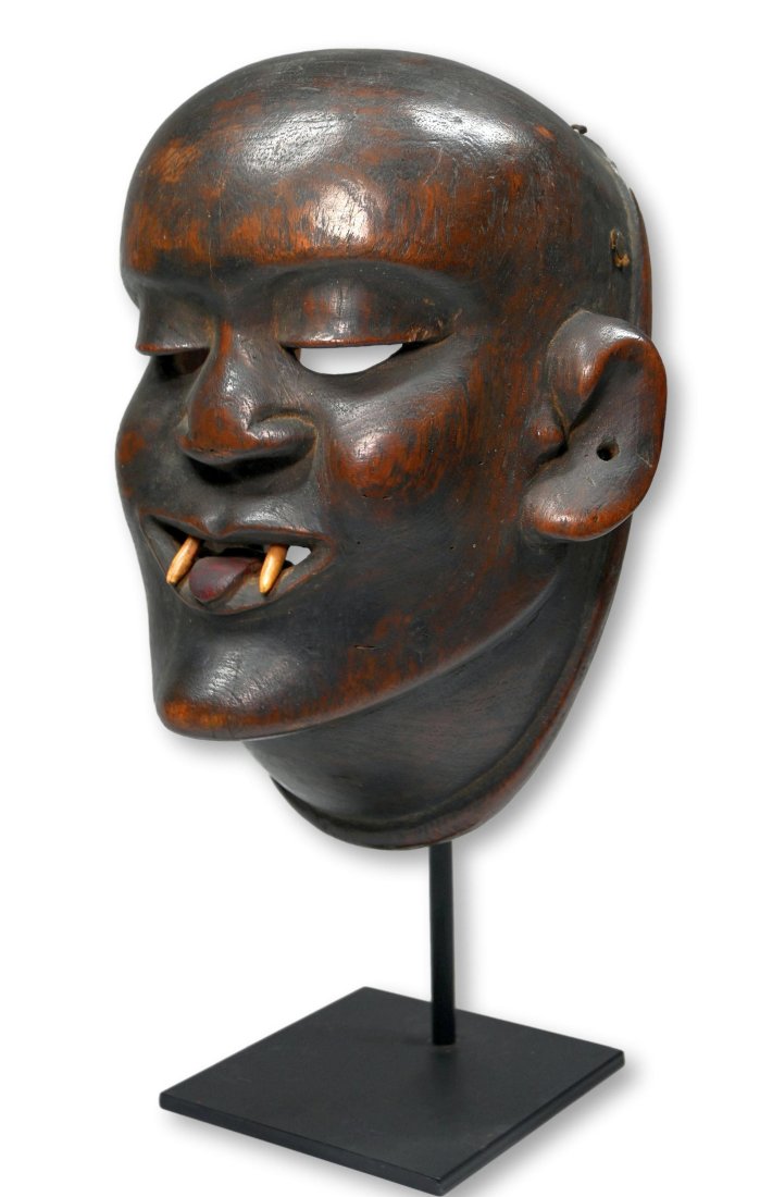 A Makonde Ceremonial Mask Ex Marshall Mount Collection: A finely carved wooden face mask with a stylized human face and vampire like real teeth fangs, and a well handled surface suggesting years of field use and wear. Makonde peoples, Mozambique, East Afri