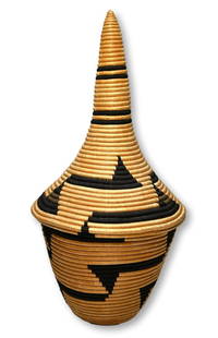 A Fine Tutsi Lidded Basket: A beautiful antique hand woven Agaseki or Ibeseke basket from the Tutsi people of Rwanda, Central Africa. This basket measures 12 inches tall x 6 inches wide with it's conical lid.