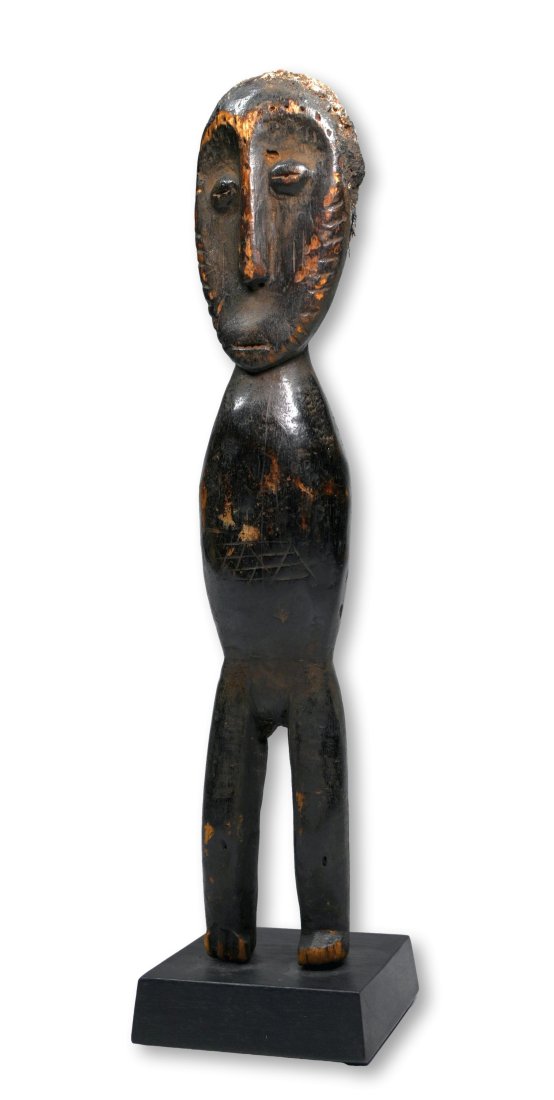A Lega Bwami Society Clan Idol Ex Gregory Votaw Collection: A primitive carved wooden secret Society cult idol with classic facial features, well handled armless simplistic torso and legs and well weathered surface. Lega peoples, Bwami Society, DRC/ Congo, cen