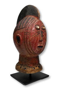 A Mossi Dance Crest: A striking carved wooden anthropomorphic dance crest of a painted Red ancestral spirit head with raised central crest, facial scar tattoos and white eyes. The head crest measures 14.25 inches tall on