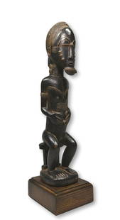 Handsome Baule Male Sculpture Ex Banks Collection: A very finely carved wooden seated male sculpture with classic facial features and form, carved coiffure, raised scar designs and well handled and worn patina. Baule peoples, Ivory Coast, West Africa.