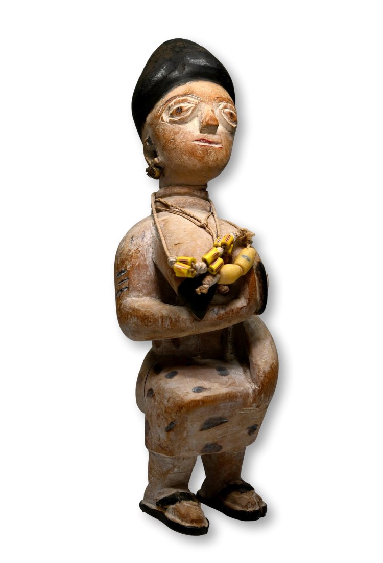 A Fanti Queen Mother Sculpture Ex Banks Collection.: A carved wooden female effigy with highly stylized face and form, shown seated on throne with one hand on her breast, suggesting a fertility aspect. The Sculpture was painted with kaolin clay pigment 