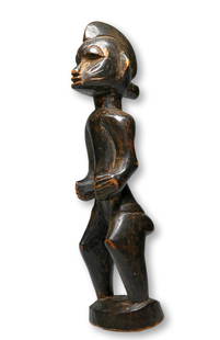 A Fine Senufo Sculpture Ex Rene and Maud Garcia, France.: A charming carved wooden female effigy with classic face and form, incised linear scar designs and a well handled surface patina. Senufo peoples, Ivory Coast, West Africa. The sculpture measures 6.5 i