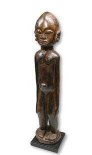 A Lobi bateba Thil Shrine Idol: A tall slender carved wooden spirit idol with a well handled surface patina and classic facial features and form, long arms down the sides and large rounded ears. Lobi peoples, Burkina Faso, West Afri