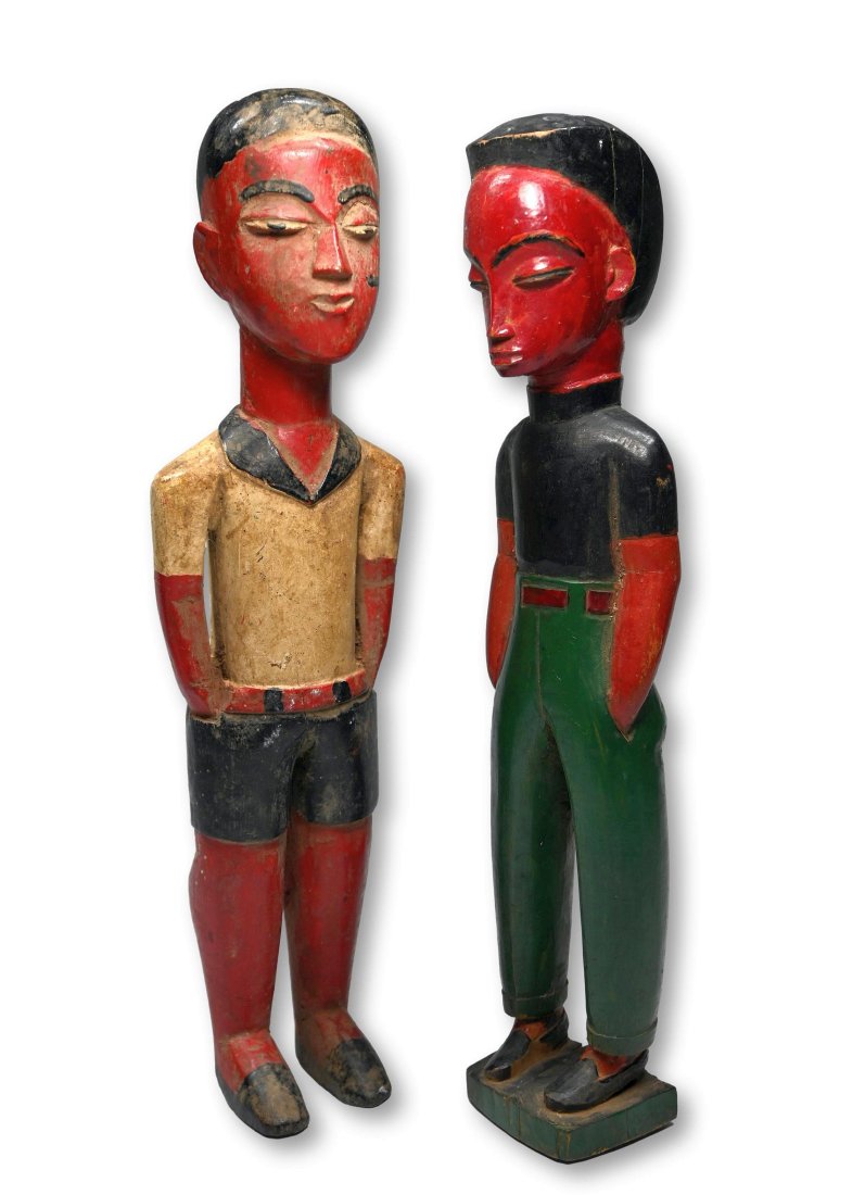A Pair of Baule Colonial Sculptures Ex Charles Miller: A finely carved and painted set of Colon sculptures with colonial style dress and dramatic red painted faces and bodies. Baule peoples, Ivory Coast, West Africa. The sculptures measure 12.75 inches ta