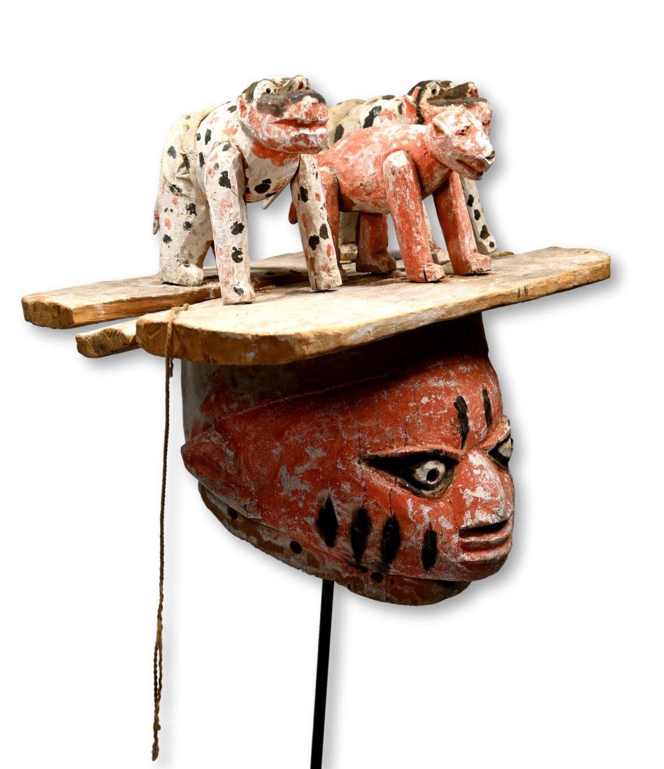 A Yoruba Gelede Festival Mask Ex Stewart Warkow Collection: A fascinating festival helmet mask with zoomorphic figures on top of a plank structure on top of the festival mask, painted in bright colors and showing signs of field use and wear. Yoruba peoples, Ni