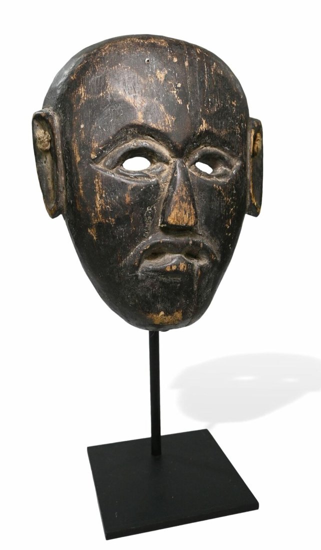 Mask of a Buddhist Monk, Nepal Tribal Mask: Carved wood with well handled surface patina, signs of field use and wear. From the North Eastern part of Nepal along the Tibetan border , used in Buddhist theatrical dances and ceremonies. The mask m