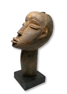 A Lobi Shrine Head Ex Scanzi Collection: A Carved wooden shrine head effigy in classic form with well handled surface patina, and a wonderful tilted back form as the spirit idol looks to the heavens. Bateba Thil sculptures such as this repre