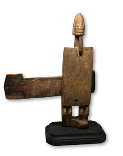 A Dogon Door Lock Ex Marshall Mount Collection: A finely carved old example of a anthropomorphic door lock with fine incised linear designs, wonderful male ancestor face and obvious age and wear. Dogon peoples, Mali, Africa. The Lock on simple wood