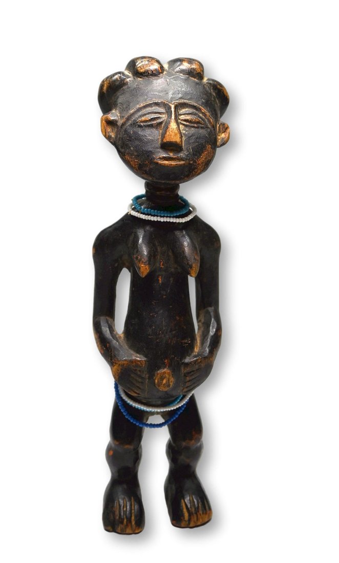 Ashanti female Shrine Effigy: This is a very fine old wood sculpture of a female ancestor with stylized face and form, carved coiffure, protruding navel and well handled and worn surface. Ashanti peoples, Ghana, West Africa. The s