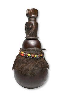 A Fine Old Kwere Medicine Gourd Ex Karl Zabel Collection: A well handled old Medicine Gourd container with carved wooden stopper in the form of a classic Mwana Hiti doll, The vessel was adorned with old glass beads and animal hide and has an undeniable well