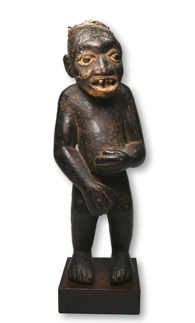 A Bamun Ancestor Shrine Idol Ex Marshall Mount Collection: A very old and interesting carved wooden male effigy from a shrine, with a deep well handled and oiled surface and carved wooden teeth, with a charming expression. A cavity in the back of the sculptur