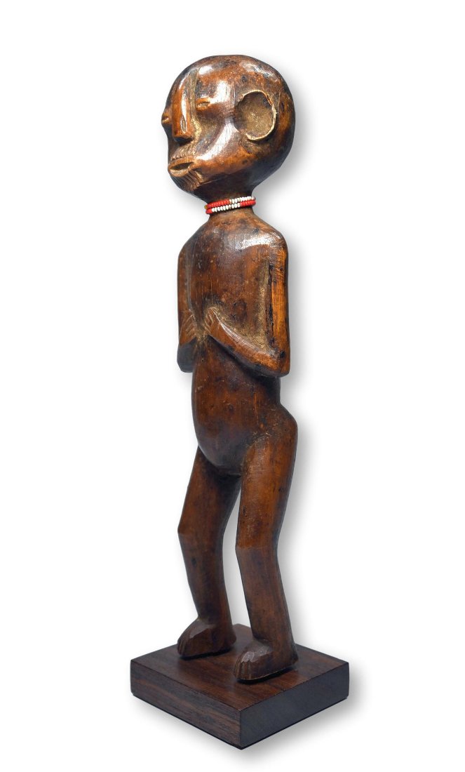 A Fine Old Nyamwezi Sculpture Ex Banks Collection: An elegant and refined example of a male effigy with hands to the chest, incised beard, pouty mouth and deep well handled surface patina. The Sculpture was reportedly once offered at Sothebys London,