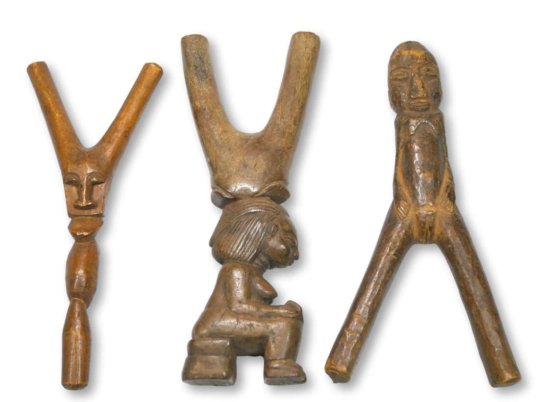 Three Antique Slingshots from Africa Ex Gould Collection: This lot contains three carved wooden slingshots from west Africa. This lot has a large slingshot from the Baule shown reading a book, a very nice old example that measures 8.25 inches tall, a well wo