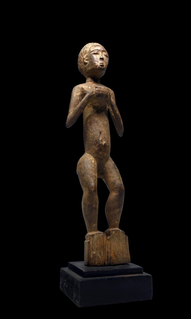 Attie Ancestor with Offering Bowl: Elegant carved wooden female effigy shown with offering bowl in her hands held to her chest. The sculpture has a well weathered surface, eroded base and measures 17.5 inches tall, 19.5 inches tall on 