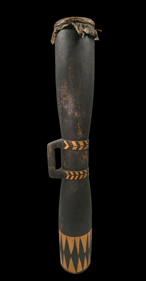 A Kiwai Island Drum: A Kiwai Island/Torres Traits drum; Kiwai Island, Western Province, Papua New Guinea.Of classical elongated waisted form, the drum with incised designs to the handle and diamond patterns at the base. F