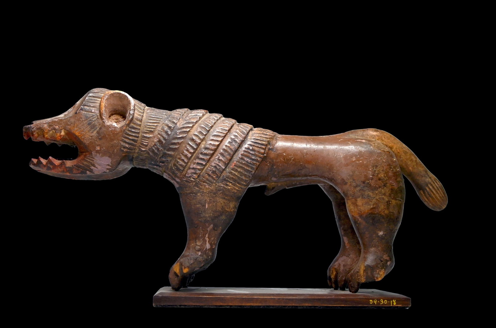 A Fon Royal Lion Ex Ernest Becker Collection: A Very finely carved wooden sculpture of a Lion with aggressive teeth , carved mane and tail, with a well handled honey colored surface patina. Among the Fon, such images are linked to the royal famil