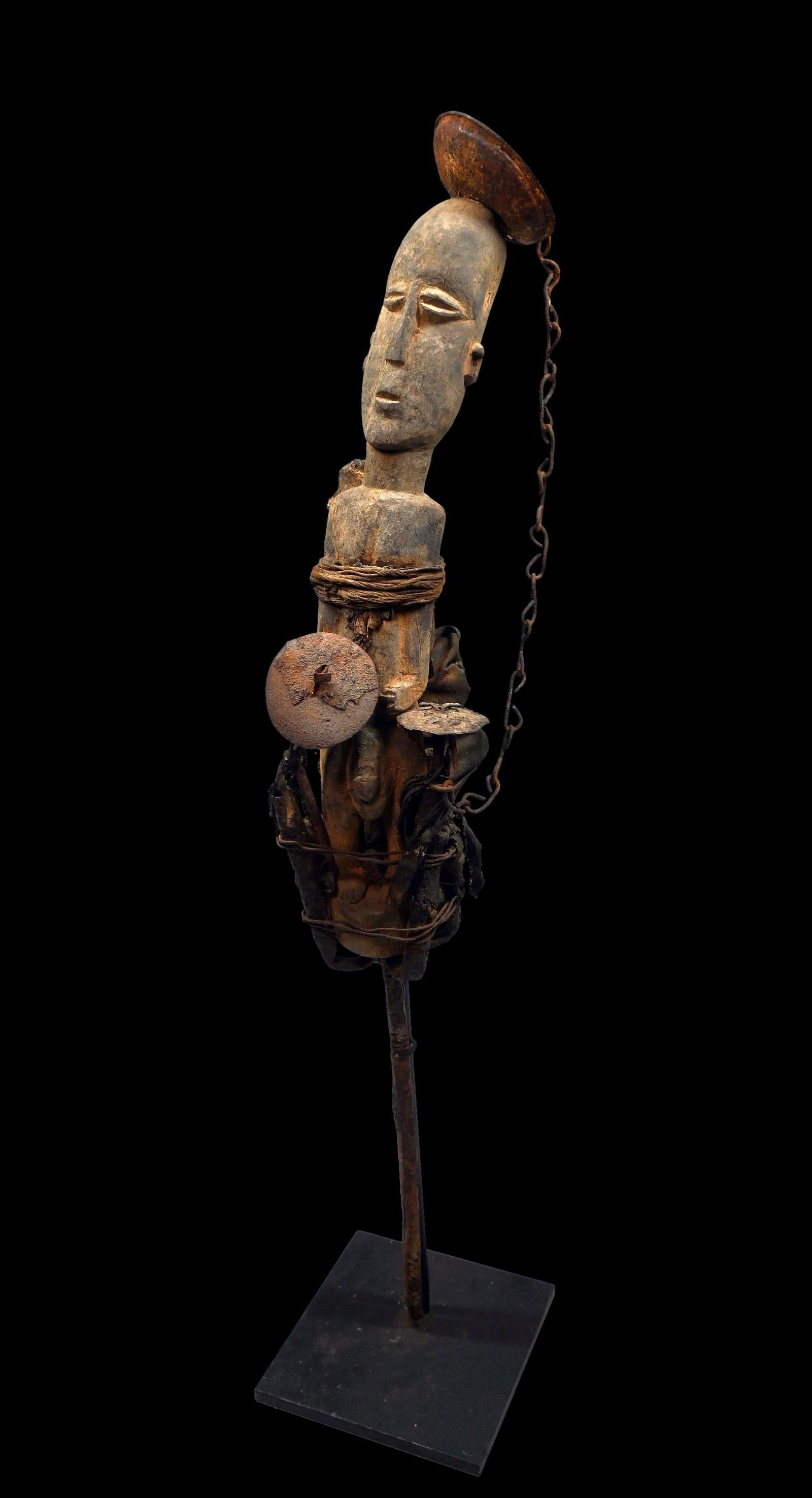 A Fon Voodoo Spike Fetish Ex Daniel Simmons Collection: A fascinating wood and iron spike fetish, with carved wooden spirit figure bound by rope and chains, and surrounded by iron and bone objects to attract the spirits. Such esoteric magic works are diffi