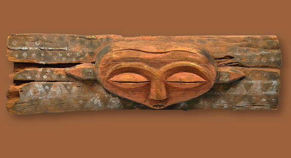 Ancient Panya Ngombe Lintel for Chiefs House: A Rare and very old Panya Ngombe Lintel for Chiefs House. A large carved wooden panel decorated with tribal motifs painted in mineral pigments around a central mask face. Likely a 19th century to