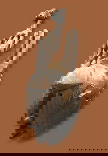 A Bamana Ntomo Mask Ex Thompson Estate: A carved wooden mask with some wonderful facial features, tall comb like crest with an ancestor figure on top. Bamana ethnic group, Mali, West Africa. The mask measures 25 x 8.5 inches. A metal