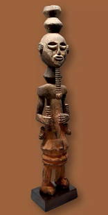 Oron Ancestor Effigy Ex Friar Biggane 1960s: Ancestor Figure (Ekpu)Ibibio peoples, Oron group, 20th century. A Carved wooden male effigy with weathered surface and earthen stained surface. Likely a mid 20th century example as it was collected