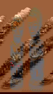 A Baule Spirit Couple Ex Banks Collection: A finely carved male and female couple of Blolo or Spirit husband and Wife sculptures with raised scar designs and classic facial features and form. Baule peoples, Ivory Coast, West Africa. The