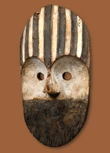 A Metoko Mask Ex Barthels Gallery: A carved wooden mask with incised linear designs accented with kaolin clay pigments. This is a rare style of mask that is difficult to research and know with certainty if it is genuine, as few seem