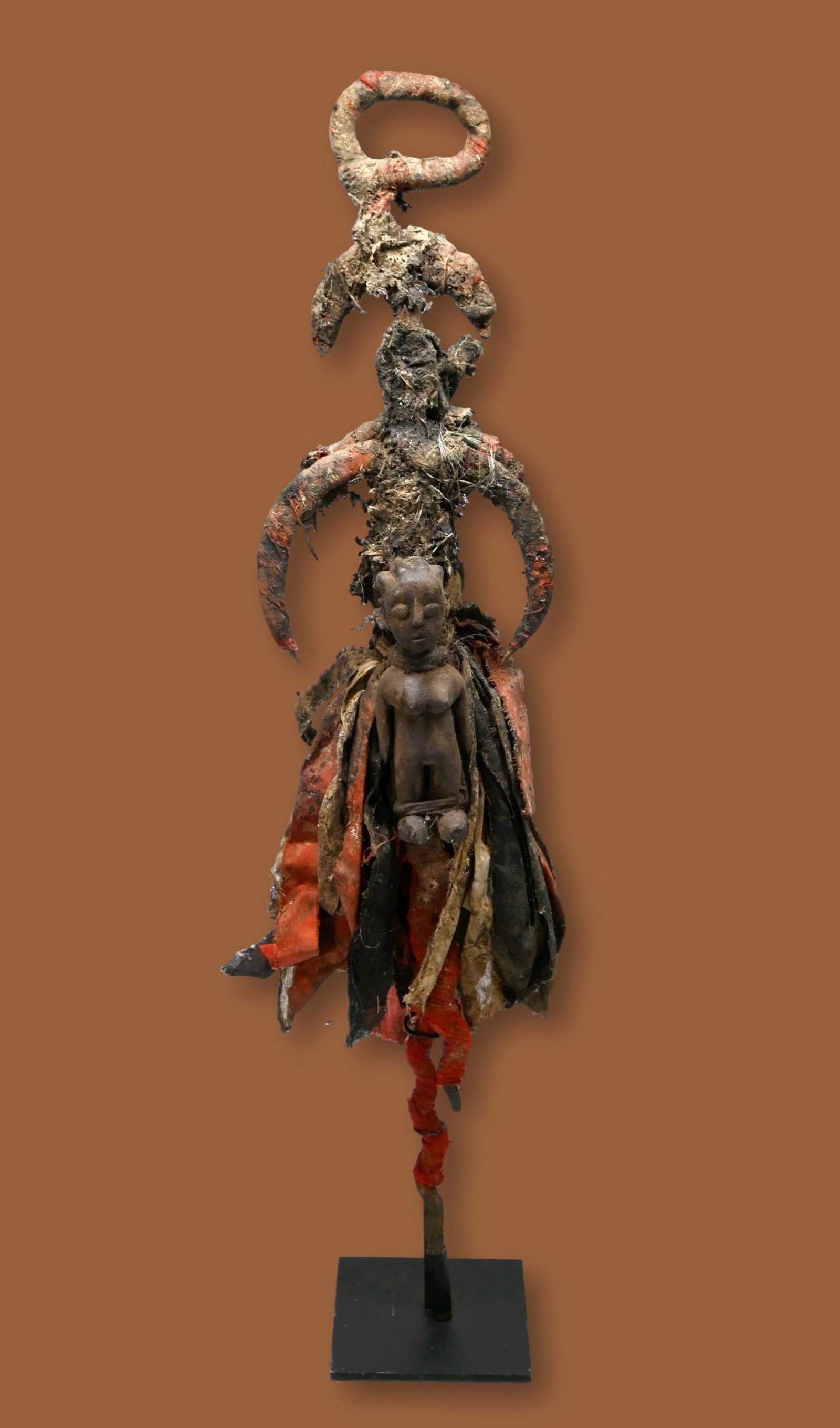 A Ewe Vodun Staff Ex Owen Hargreaves: A wrought iron ritual staff adorned with various symbols and ritual material related to voodoo or Vodoun, including a wooden spirit idol, Hevioso iron symbols which represent the God of heaven, thunde