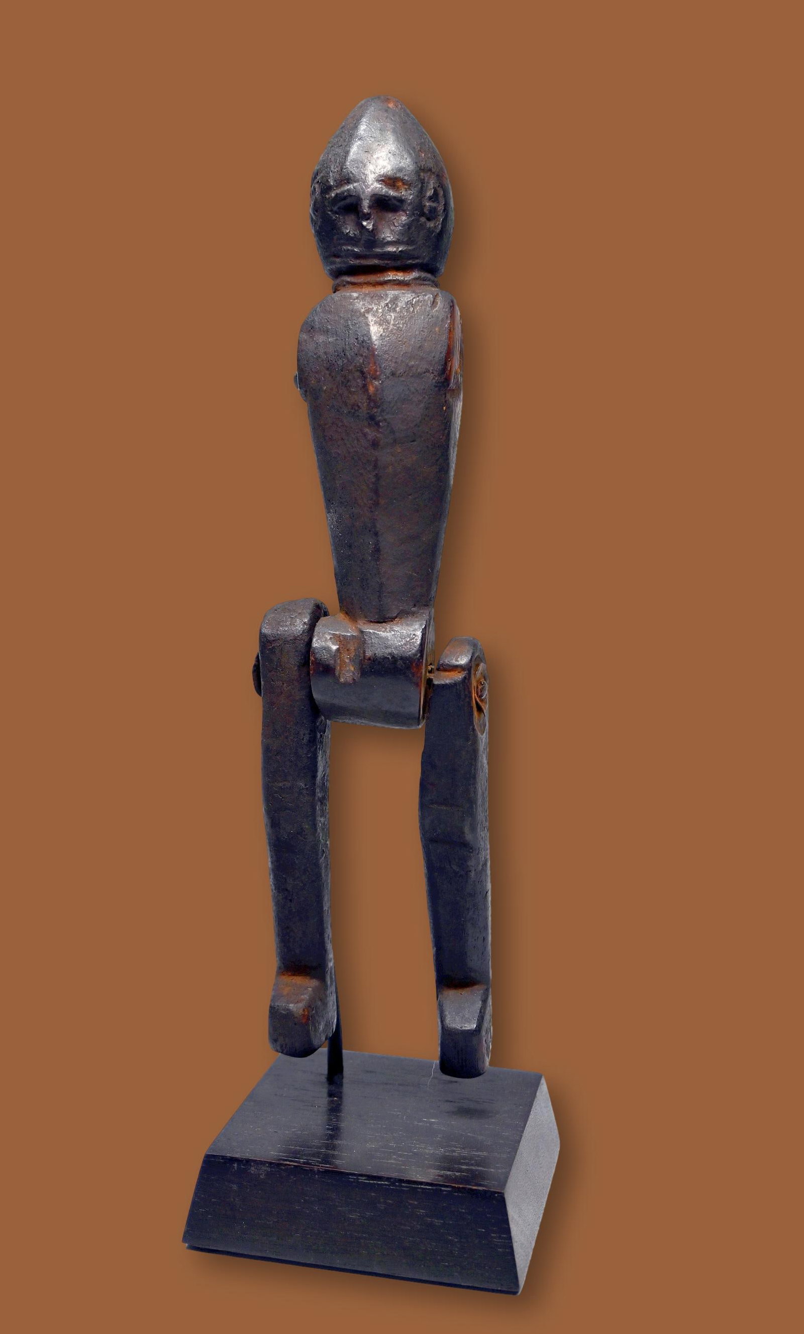 A Marionette Doll from Nepal: A carved wooden vintage to antique wooden doll with movable legs and likely at one time had hanging arms , carved facial features and well worn surface. Nepal. The doll measures 10.75 inches tall on c