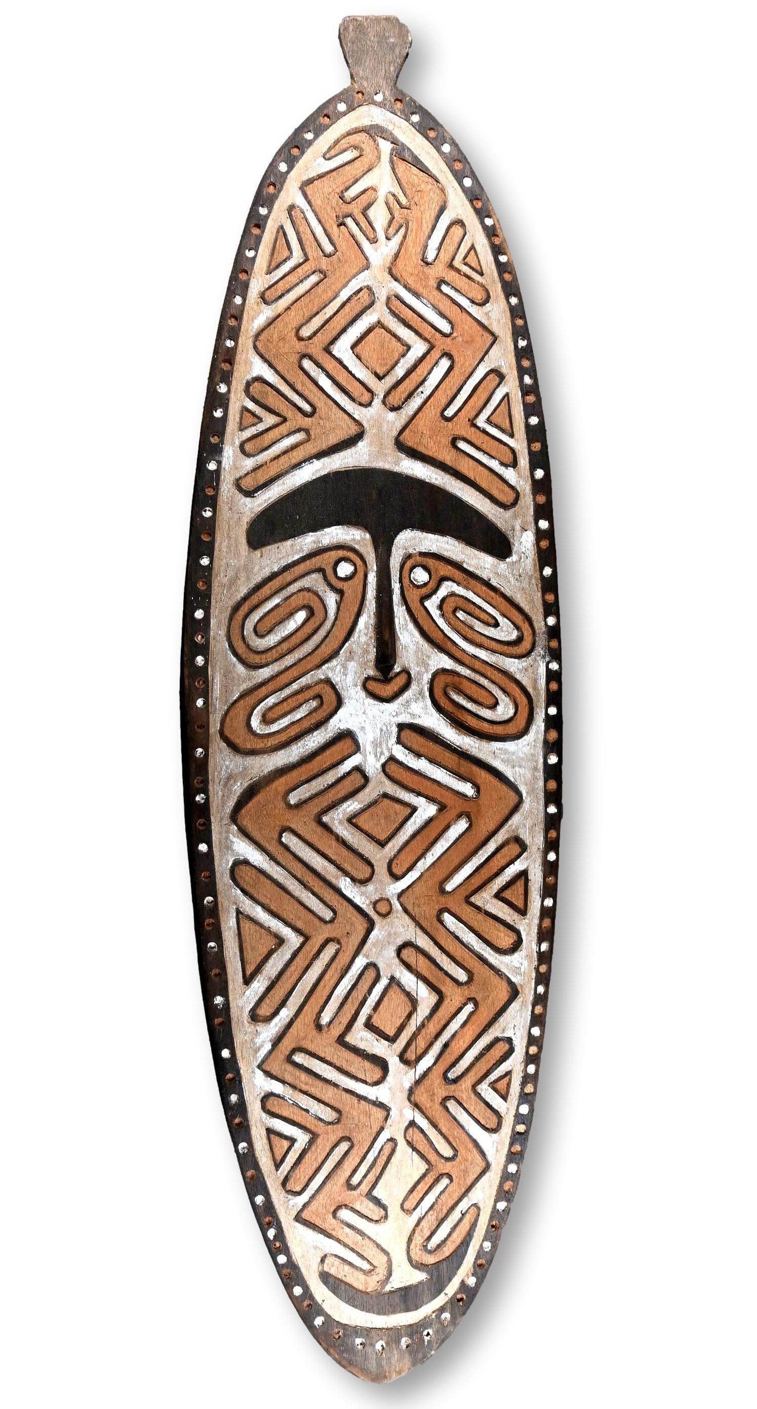A Kikori Gope Spirit Board: A Kikori area spirit board (Gope), Gulf province Papua New Guinea. A classic example for the region, with central stylized face surrounded by spiral motifs. Spirit boards were believed to be the abode