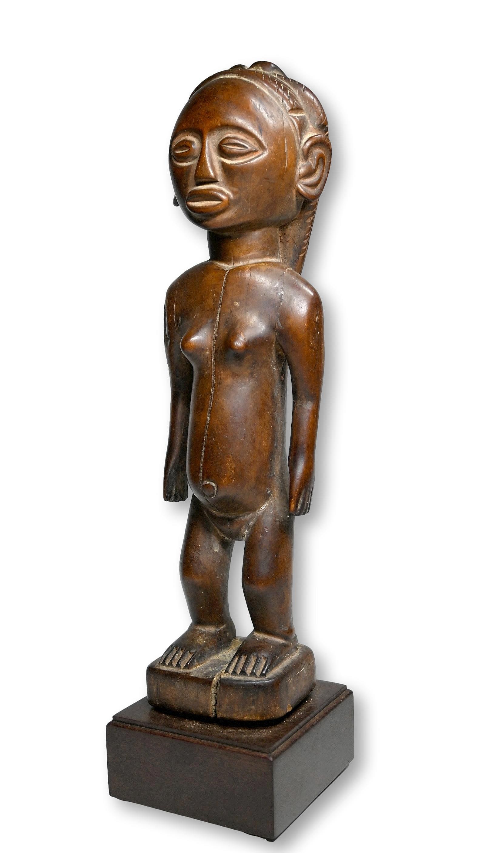 A Tabwa Female Sculpture: A Carved wooden female effigy with well handled and worn surface, long stylized coiffure down her back and dramatic facial expression. Tabwa peoples, DRC/Congo, Africa. The sculpture has been custom m