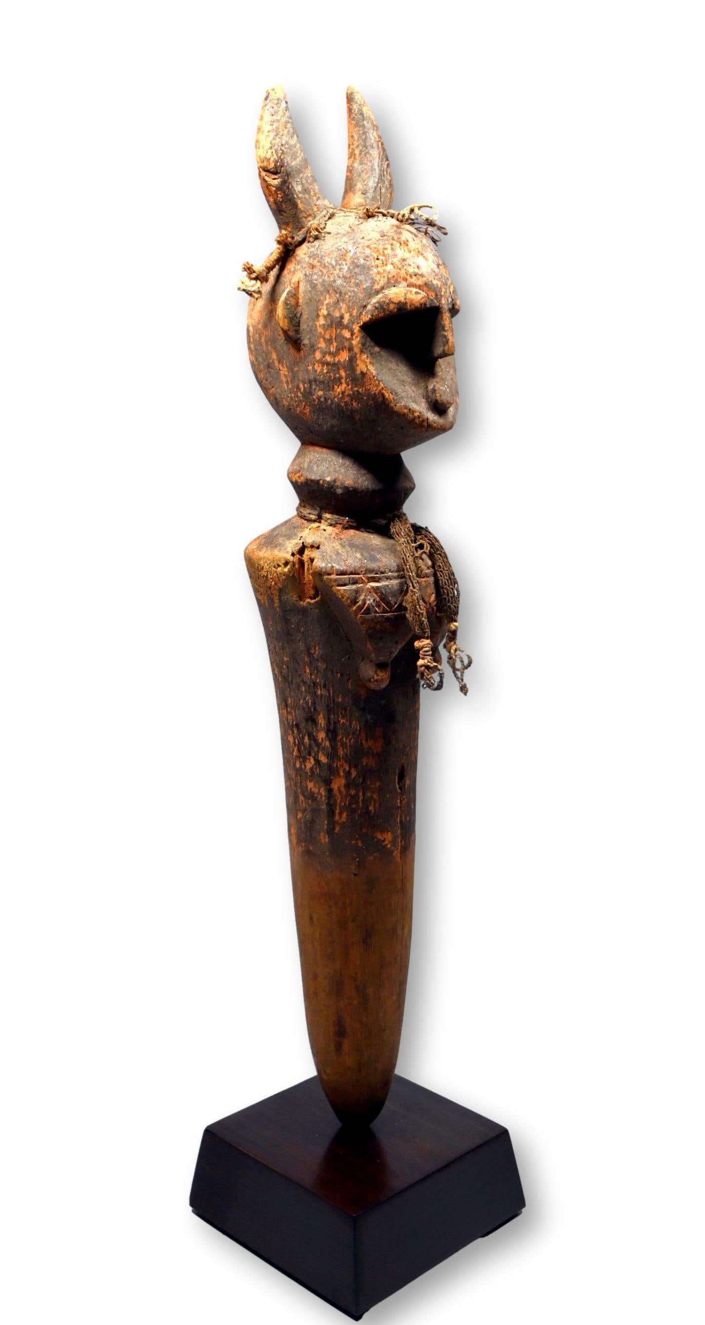 A Toma Shrine Sculpture: A stylized old sculpture of a horned ancestor head atop a post like form, with possible ceremonial use on a shrine. The surface patina and overall wear are quite convincing that this is a genuinely ol
