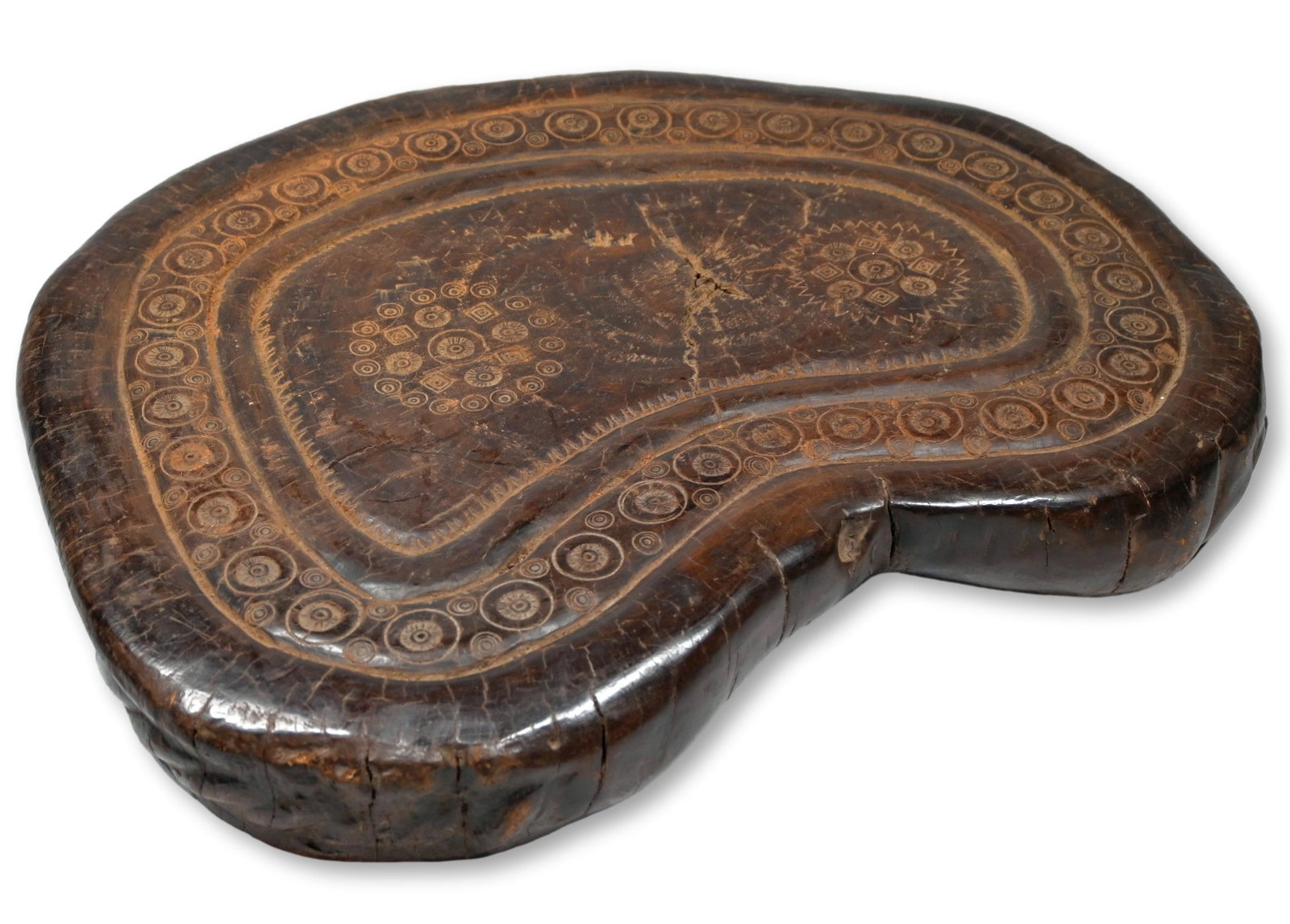 A Healing Shrine or Altar from India: This is a unusual old carved wooden shrine or altar with elaborate incised designs and signs of heavy use and wear over many years. This large table or seat has extensive wear on the bottom, so much s