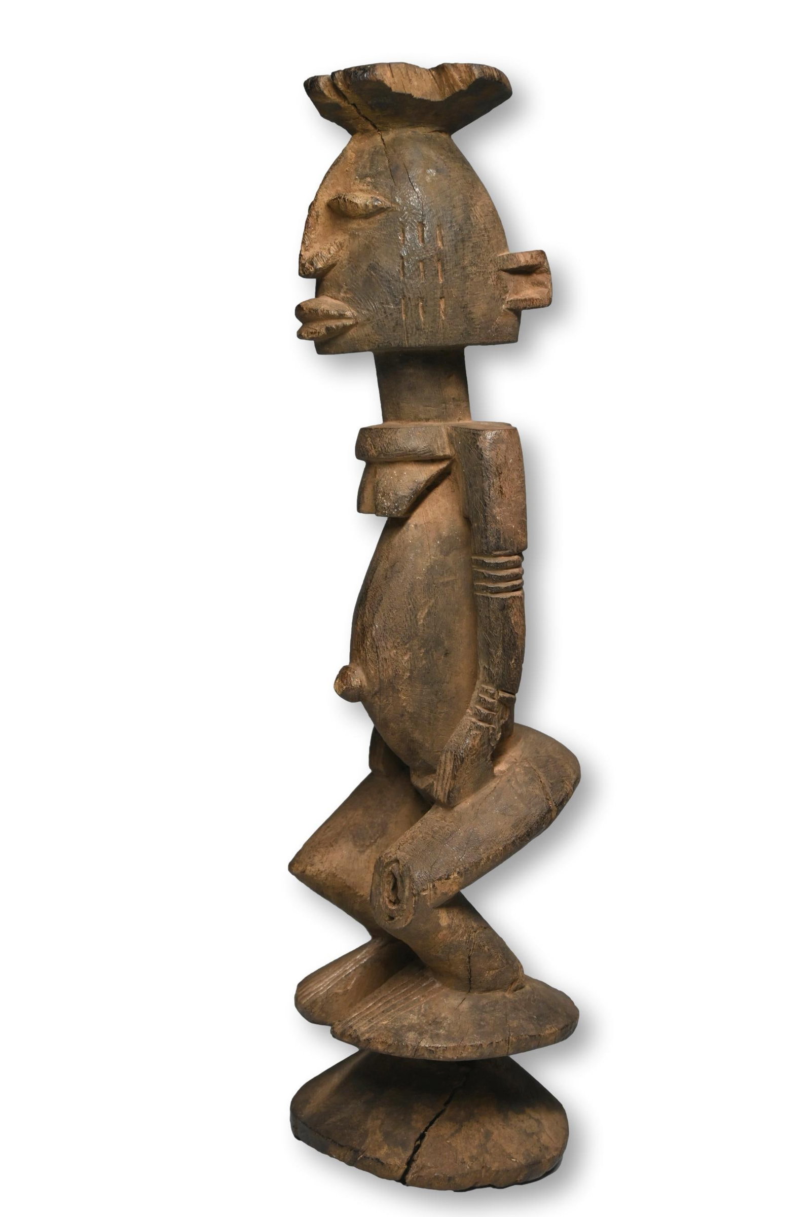 A Dogon Seno Female Sculpture: A well weathered and worn older female ancestor sculpture from the Seno plains region of Dogon country, Dogon peoples, Mali, West Africa. This unique Seno style is quite desirable among collectors.The