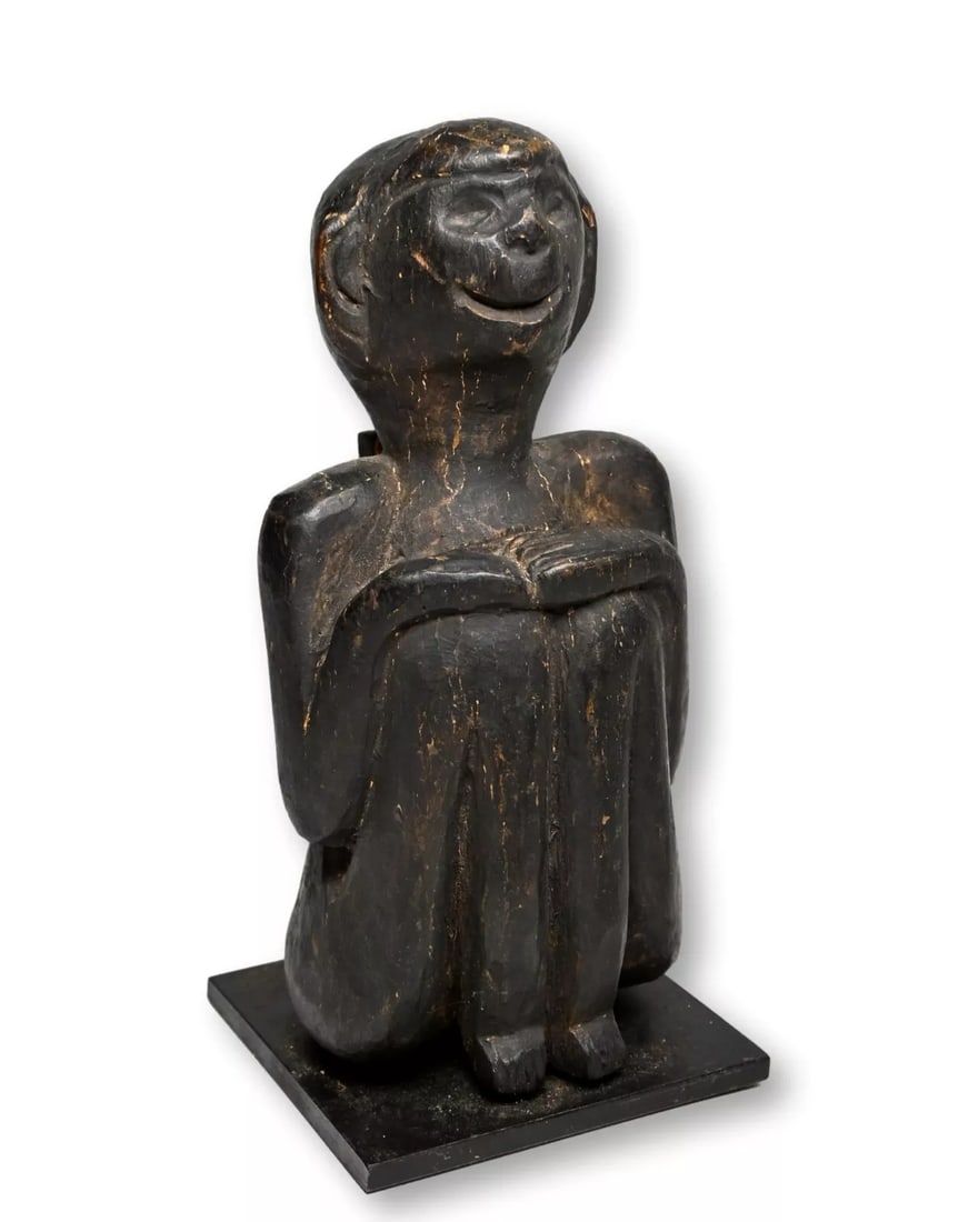 A Monkey Sculpture from Nepal: A carved wooden effigy in zoomorphic form of a Monkey, possibly that of Hanuman. The figure is well weathered and worn suggesting age and field use in Nepal. The sculpture measures 7.75 inches tall on