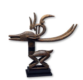 A Fine Female Chiwara Ex Galerie Noir d'Ivoire 1994: A elegant and refined carved wooden headdress featuring a mother antelope and her stylized child on her back. This classic Chiwara headdress was most likely originally carved in Bamako or the Beludegu