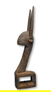 Bamana Crest Mask Sogonikun Ex Davis Collection: A carved wooden female antelope with stylized form, incised linear designs and well weathered surface. This Chiwara Headdress was likely carved in the Sikasso region, Bamana peoples, Mali, West Africa