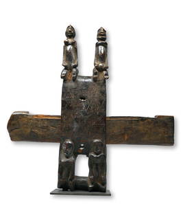 A Dogon Door Lock: A Carved wooden traditional door lock with four ancestor type anthropomorphic figures and incised linear designs, obvious field use and wear. The Lock measures 15.5 x 15 inches. Dogon peoples, Mali, W