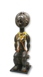 A Fine Attie Seated Female Ex Xanadu Gallery: A very fine Seated female ancestor sculpture, carved from a dense heavy wood with serene facial expression and classic form, well handled. The sculpture measures 22.25 inches on a professional quality
